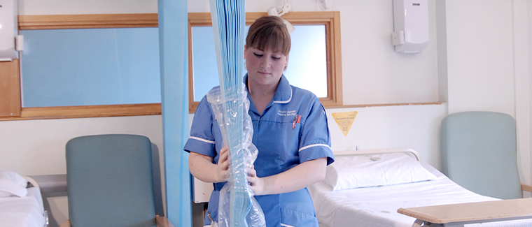 nurse with disposable curtain